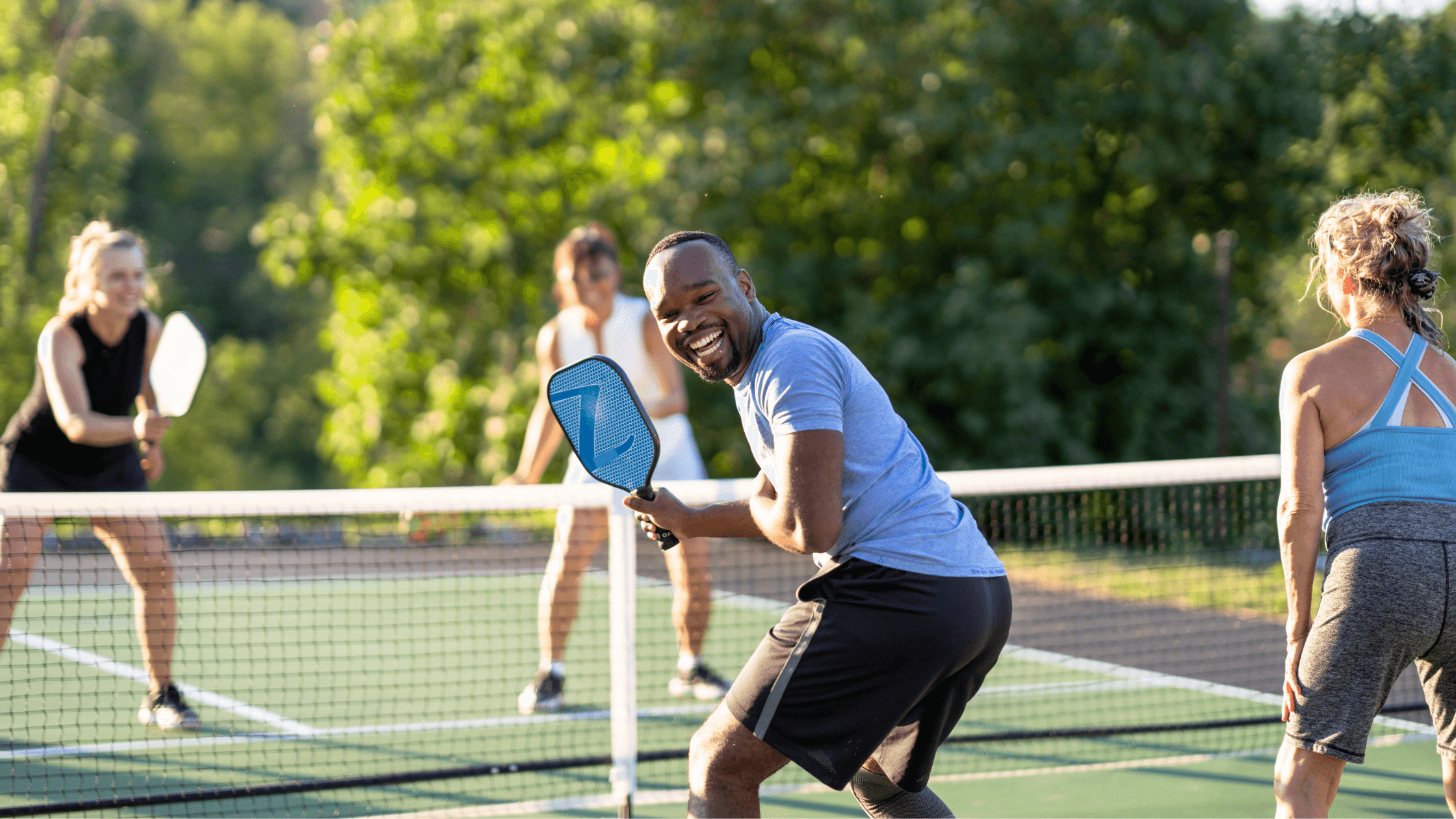 Happy man playing tennis, free from glasses after LASIK surgery