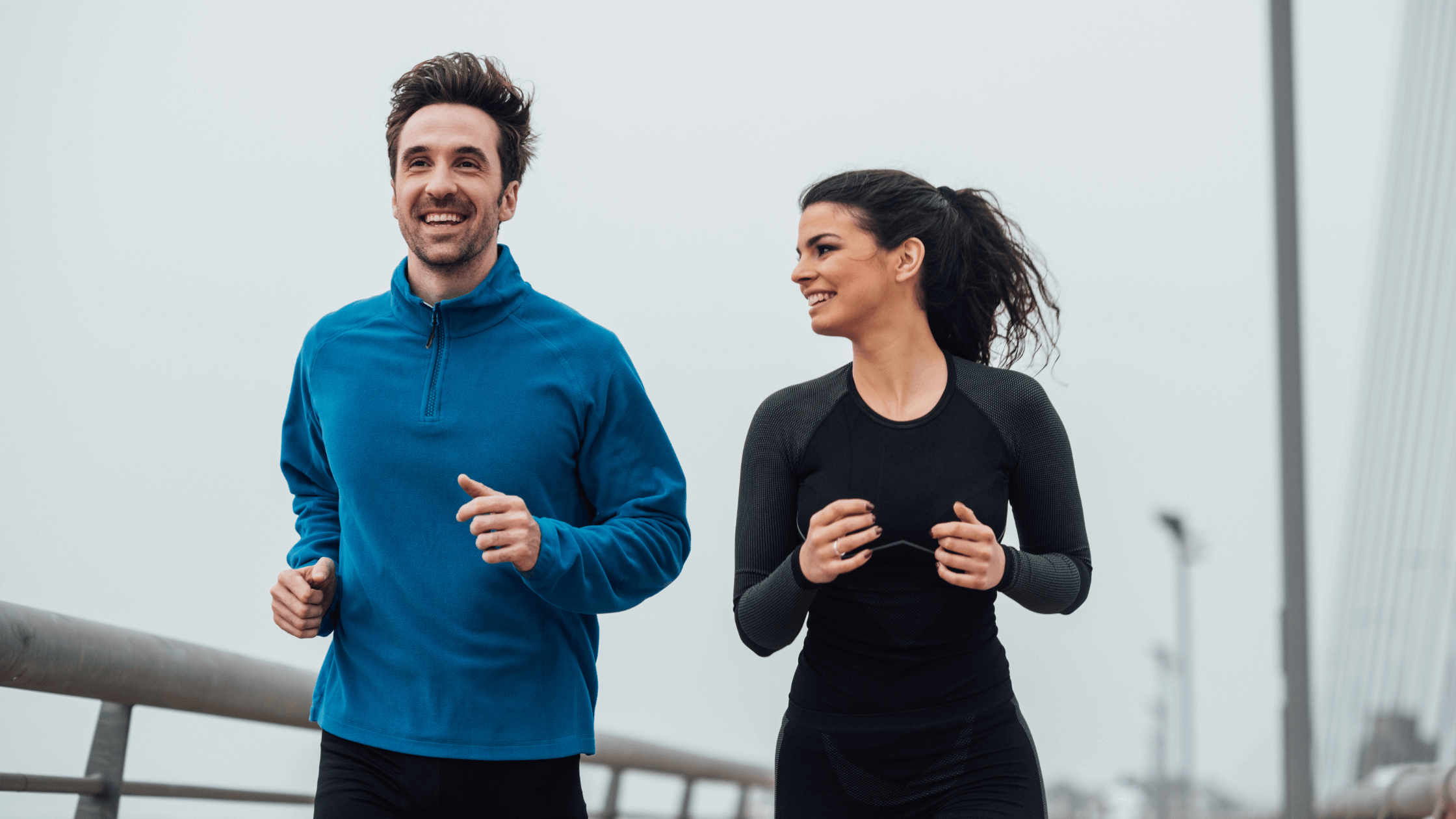 Man and woman running to maintain a healthy lifestyle and prevent ocular diseases with regular eye exams.